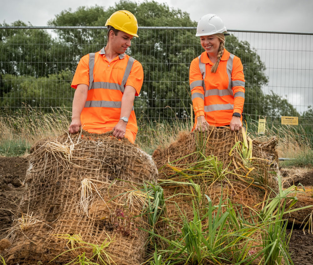 Two members of the FiveRivers team during a wetland construction project